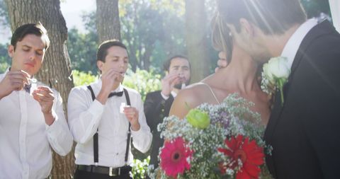 Groomsmen Blowing Bubbles at Outdoor Wedding Celebration - Download Free Stock Images Pikwizard.com