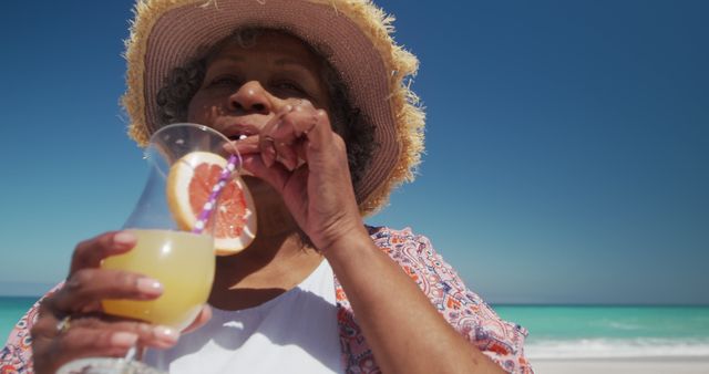 Senior Woman Enjoying Drink on Tropical Beach - Download Free Stock Images Pikwizard.com