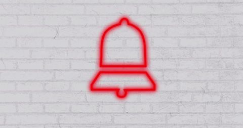 Red Neon Bell Icon Against White Brick Wall
