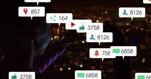 Woman silhouette holding smartphone at night with social notifications and urban city bokeh