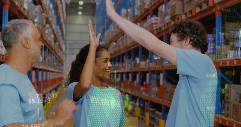 Diverse Volunteers High Fiving in Warehouse Success Concept