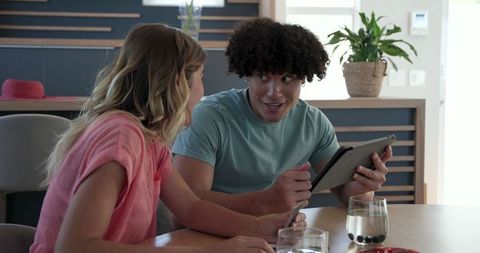 Young couple exploring online shopping together at home