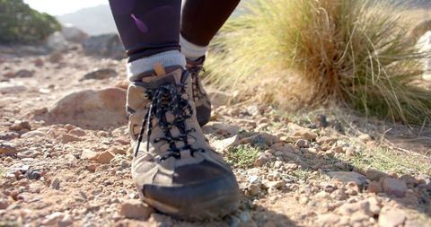 Close-up of hiking boots on rocky trail in nature