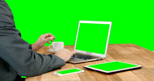 Businessman Working on Laptop with Green Screens at Desk - Download Free Stock Images Pikwizard.com