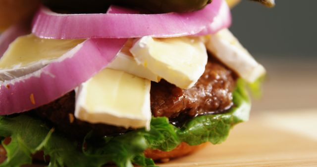 Close-Up of Gourmet Cheeseburger with Onion and Lettuce - Download Free Stock Images Pikwizard.com