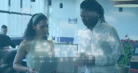 Collaborating over tablet showing AR analytics and data overlays in modern coworking office