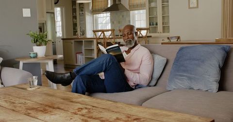 Senior Man Relaxing with a Book in Cozy Living Room