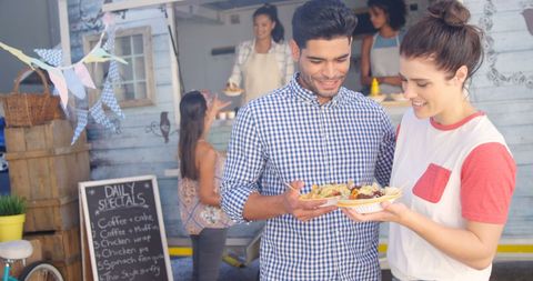 Young Couple Enjoying Street Food at Lively Outdoor Market - Download Free Stock Images Pikwizard.com