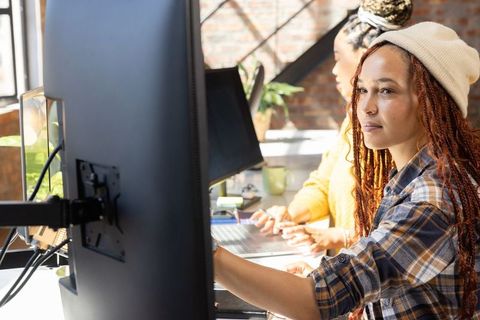 Diverse coworkers collaborating in open plan office setting