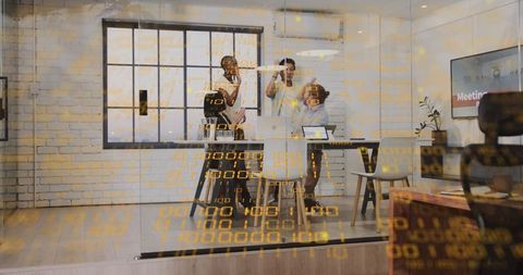 Business team high-fiving in glass conference room celebrating success with digital data overlay