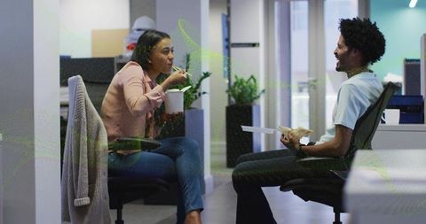 Colleagues Sharing Lunch Casually in Open-Plan Office