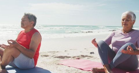 Senior Couple Meditating on Beach Keeping Active Lifestyle - Download Free Stock Images Pikwizard.com
