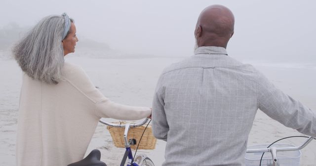 Seniors Enjoying Peaceful Bike Ride on Foggy Beach - Download Free Stock Images Pikwizard.com