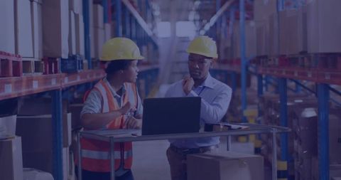 Warehouse Workers in Safety Gear Discussing Logistics Managment