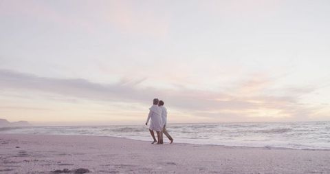 Romantic Senior Couple Strolling on Tranquil Beach at Sunset - Download Free Stock Images Pikwizard.com