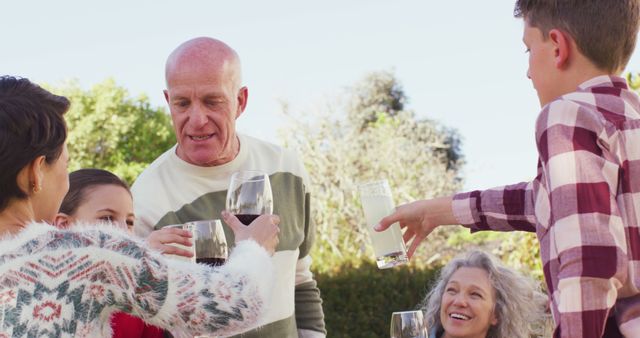 Multi-generational family toasting outdoors - Download Free Stock Images Pikwizard.com