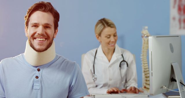 Smiling Man With Neck Brace Visiting Female Doctor in Clinic - Download Free Stock Images Pikwizard.com