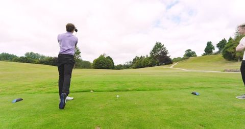 Two Friends Enjoying a Game on Scenic Golf Course