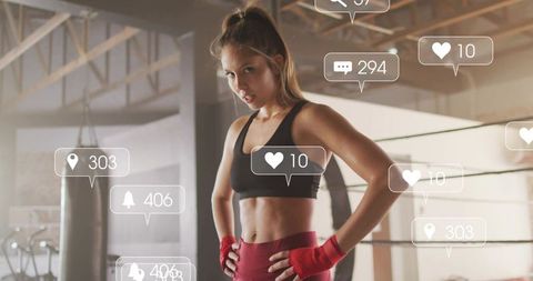 Female boxer standing hands-on-hips in gym displaying social media engagement icons