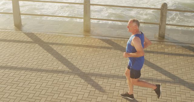 Senior Man Jogging by the Ocean at Sunrise - Download Free Stock Images Pikwizard.com