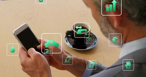 Senior businessman using smartphone displaying green augmented reality sustainability icons