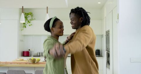 African American Couple Dancing in Modern Kitchen Sharing Intimate Moment