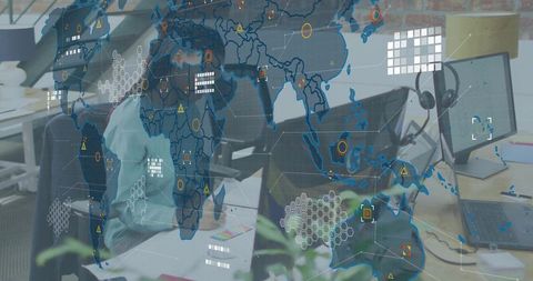 Woman analyzing global data visualization overlay on modern office workspace