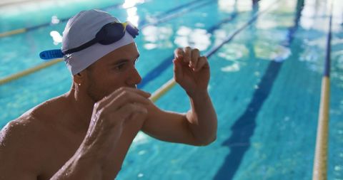 Competitive Swimmer Focused Before Race in Indoor Pool