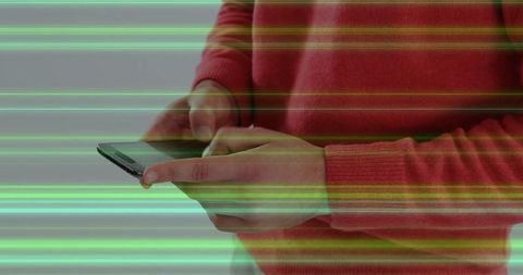 Person using smartphone interacting with holographic display