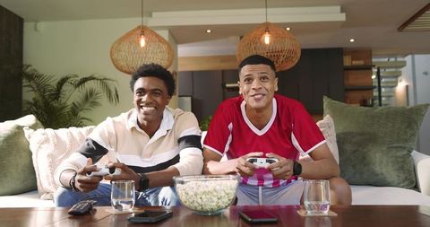 Diverse Friends Enjoy Gaming at Home Relaxed and Cheerful