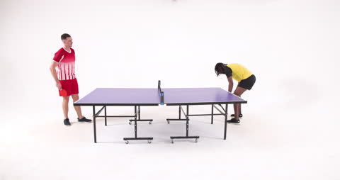 Players Strategizing for Table Tennis Match in Studio