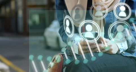 Businesswoman using smartphone with holographic interface elements