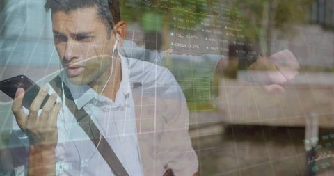 Commuter Talking on Smartphone with Earbuds and Smartwatch, Stock Market Charts Overlay