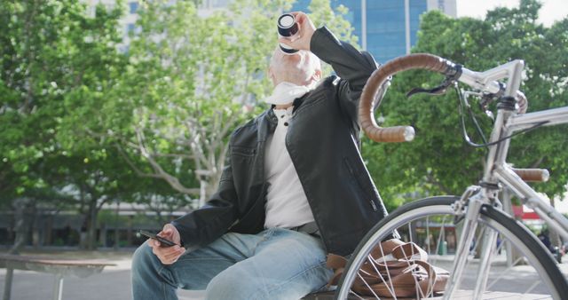 Senior Man Drinking Coffee on Bench Next to Bicycle in Urban Park - Download Free Stock Images Pikwizard.com