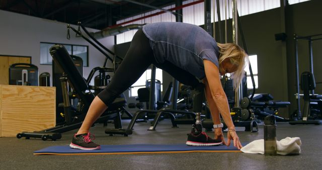 Senior Woman Stretching on Gym Mat - Download Free Stock Images Pikwizard.com