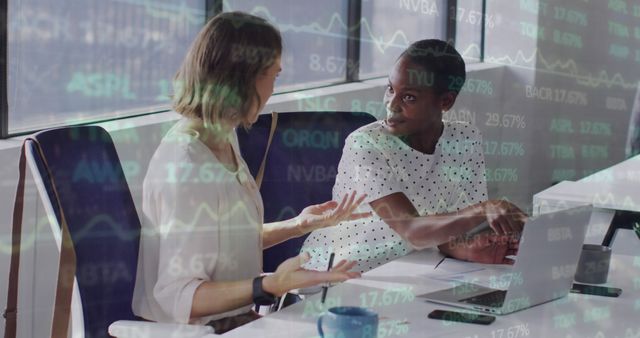 Two Female Colleagues Analyzing Financial Data in Modern Office - Download Free Stock Images Pikwizard.com