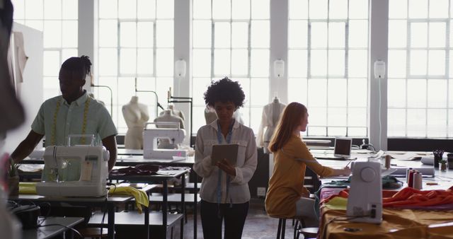 Designers Working in Fashion Studio with Sewing Machines and Dress Forms - Download Free Stock Images Pikwizard.com