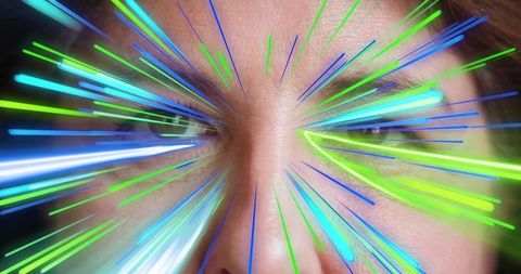 Mature woman close-up radiating neon blue green light streaks with intense futuristic gaze