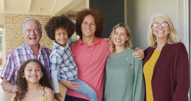 Image of happy diverse family standing outside of house. Family life, spending time together with family.