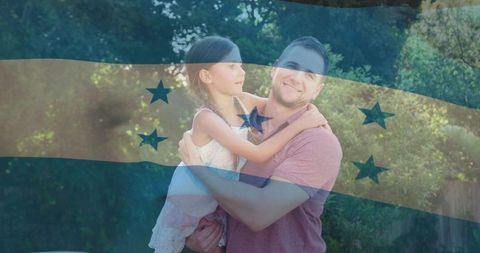 Father holding daughter in garden with honduras flag overlay celebrating family pride