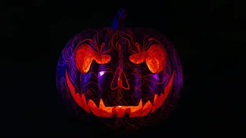 Pulsing LED Pumpkin with Skull Carving and Vine Patterns