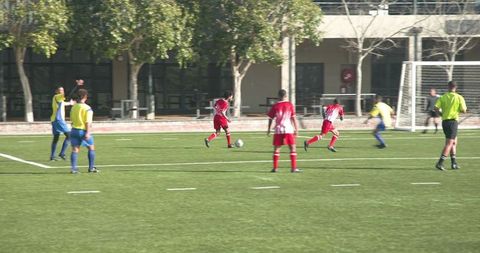 Youth soccer team playing match in action outdoors