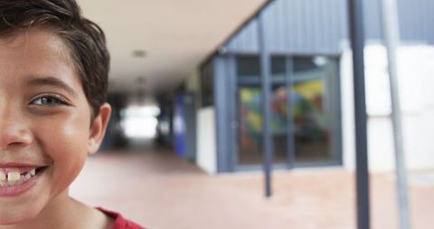 Joyful Biracial Student Smiling in School Corridor