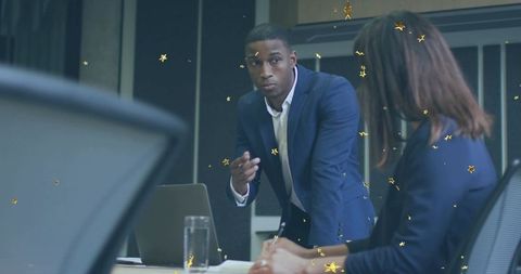 Executive Leading Boardroom Meeting, Gesturing Over Conference Table in Modern Office