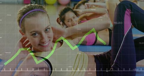 Smiling women performing group core workout in colorful fitness studio with data overlay