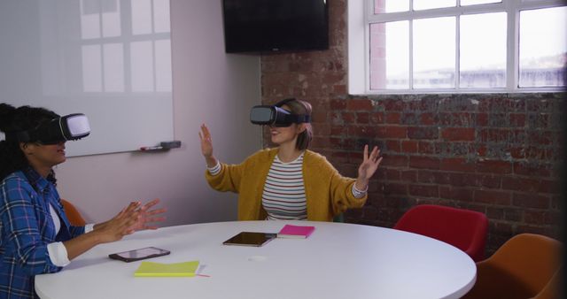 Two Women Experiencing Virtual Reality in Modern Office - Download Free Stock Images Pikwizard.com