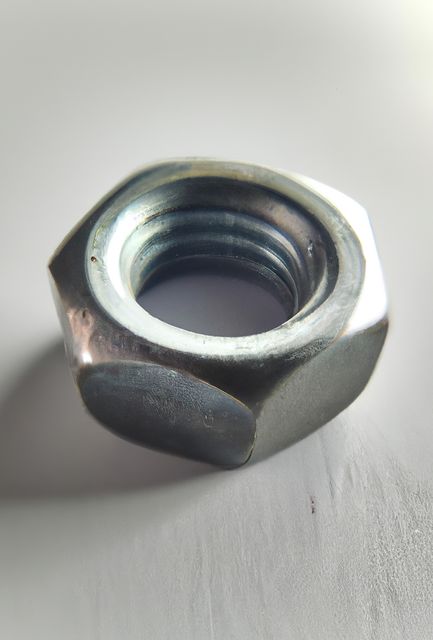 Close-Up Metal Hex Nut on White Surface - Download Free Stock Images Pikwizard.com