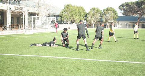 Soccer Players Engaged in Intense Match on Sunny Field