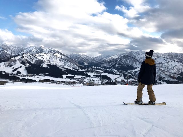 Snowboarder Enjoying Mountain View at Ski Resort - Download Free Stock Photos Pikwizard.com