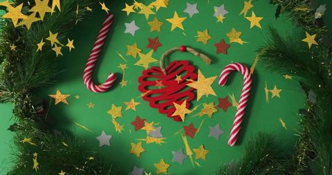 Festive christmas decoration with candy canes and star confetti